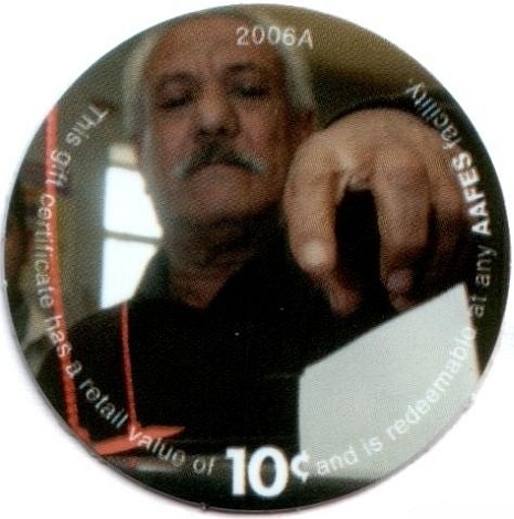 Iraqi citizewn placing  paper ballot in voting box