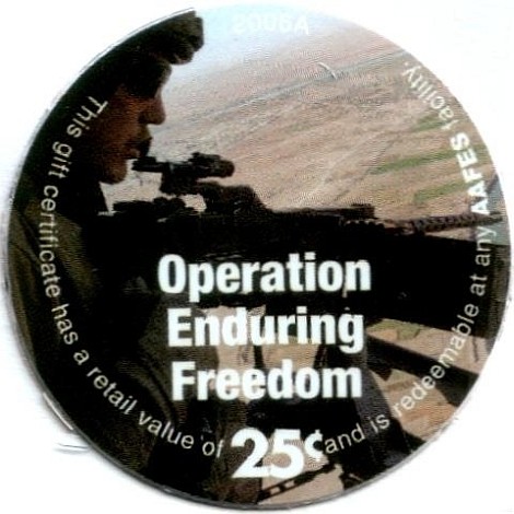 Soldier flying ina  helicopter manning a machine gun