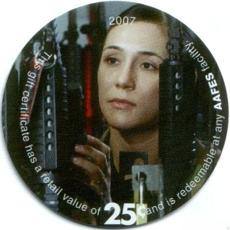 Female soldier looking  between racks of M-16 rifles